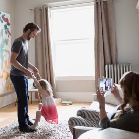 Parents playing with daughter.