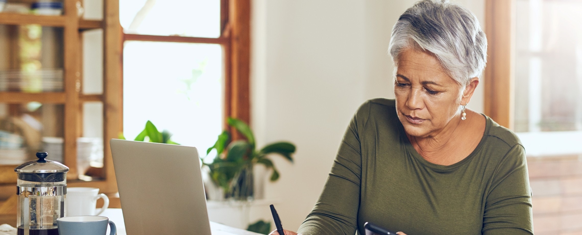 Older woman doing calculations.