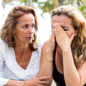upset woman consoled