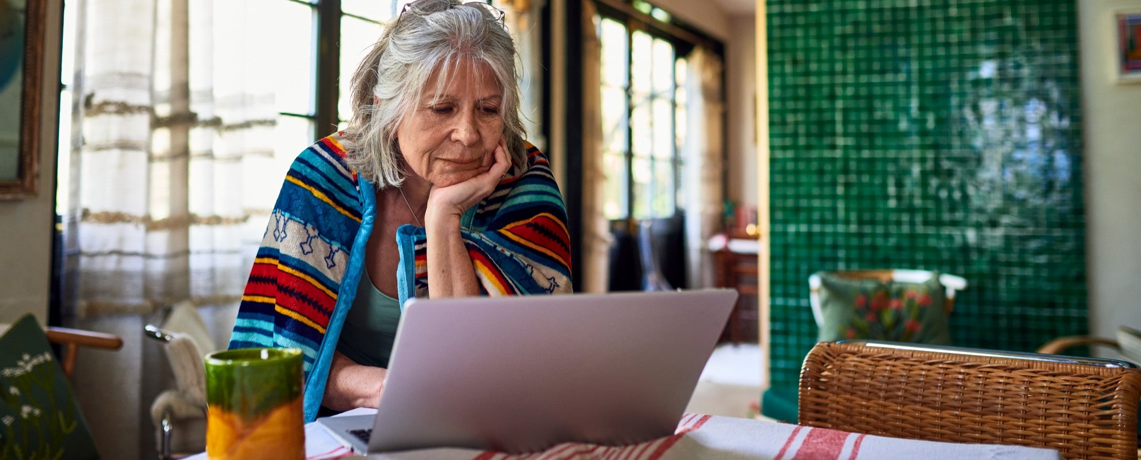 older woman pondering computer