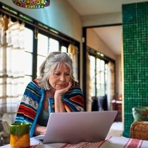 older woman pondering computer