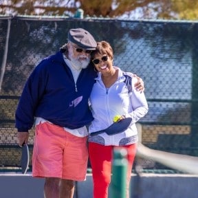 Senior couple playing pickleball