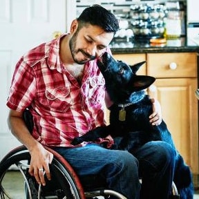 man in  wheelchair and dog