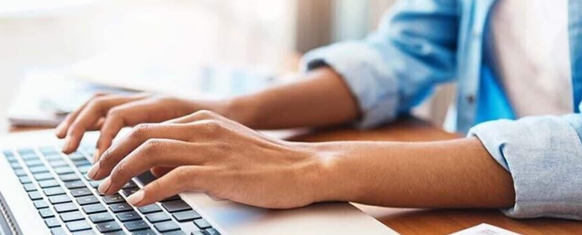 Woman typing at keyboard