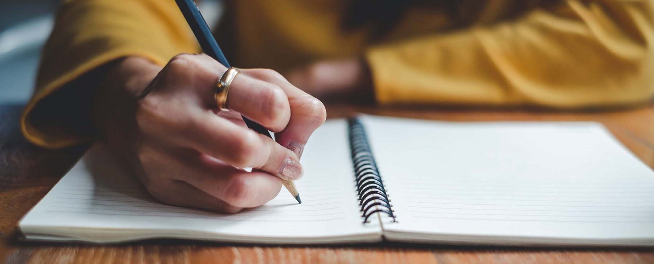 Person writing in notebook.