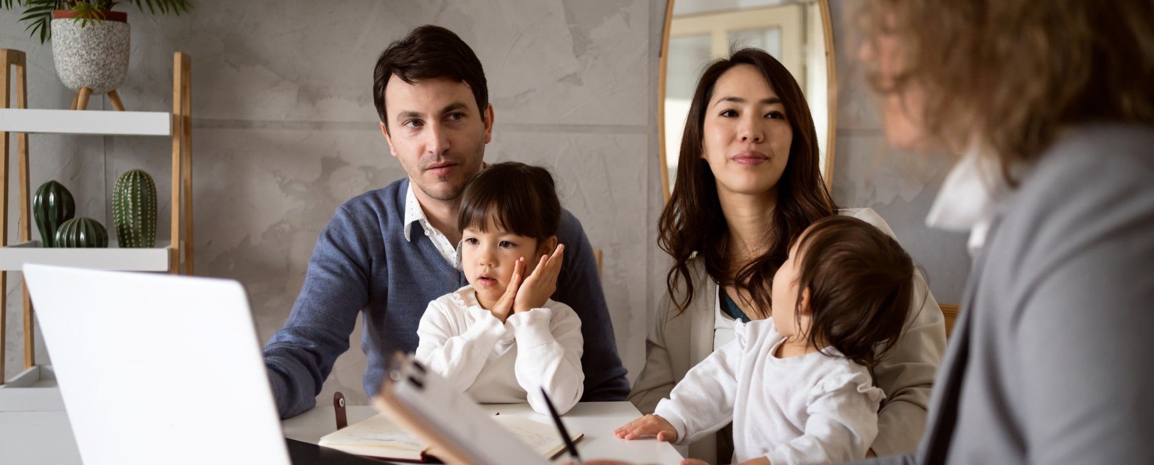 Couple with children meeting with their financial professional.