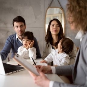 Couple with children meeting with their financial professional.