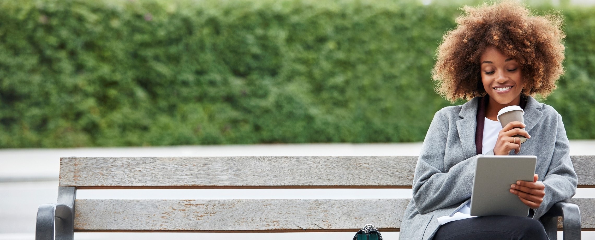 Young adult sitting on park bench.