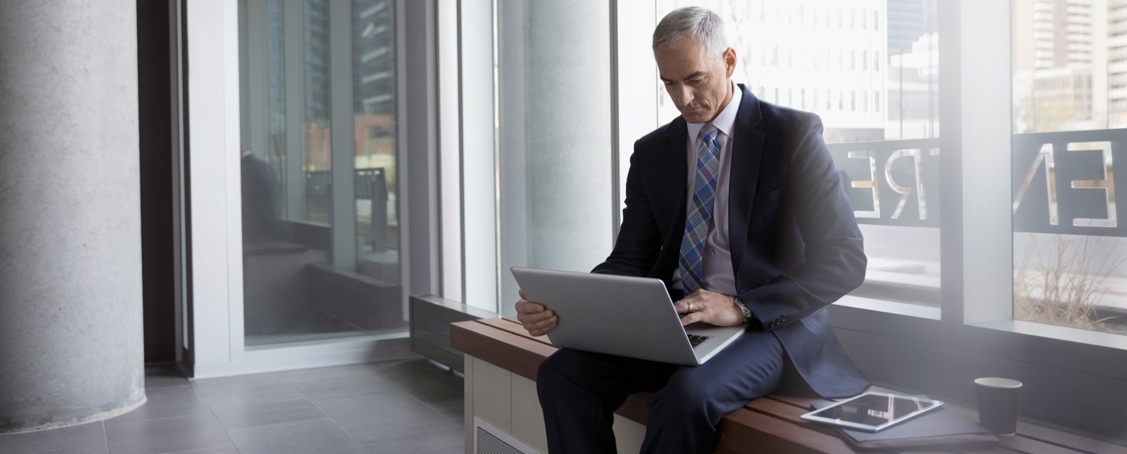 older man studying computer