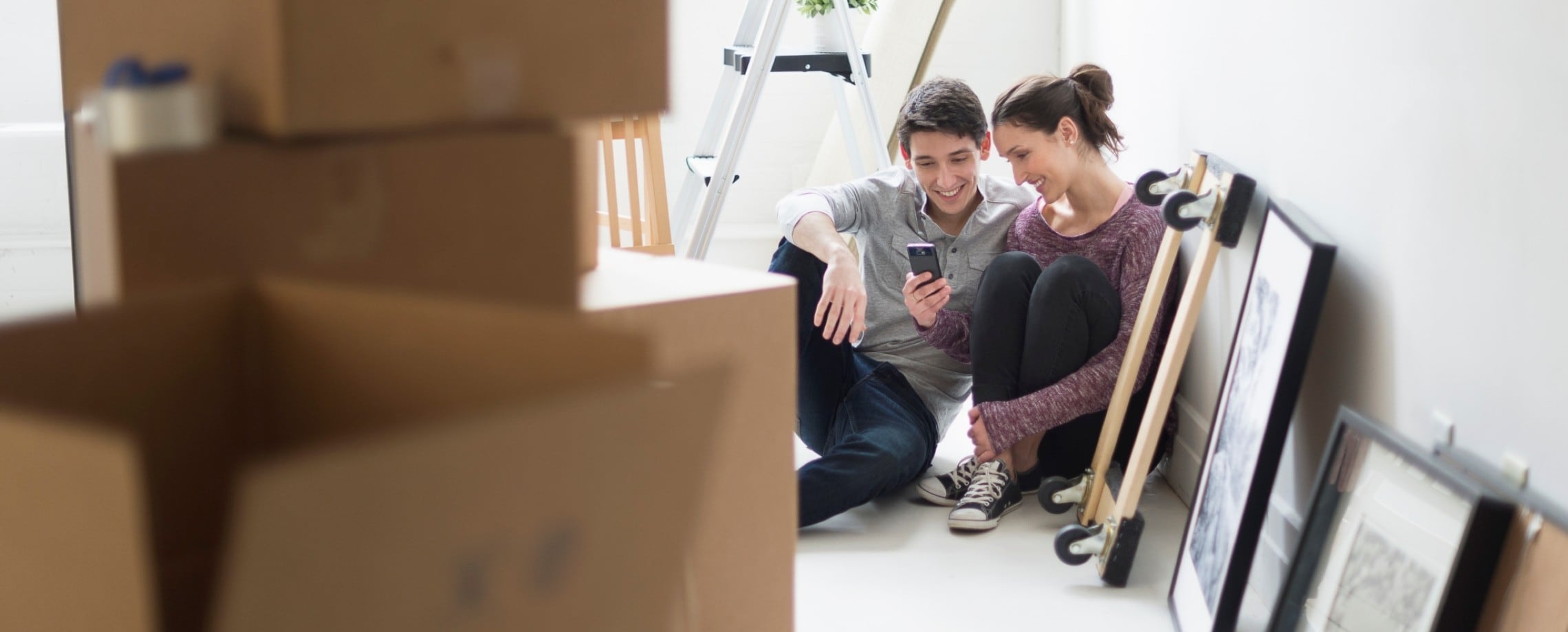 young couple taking a moving boxes break
