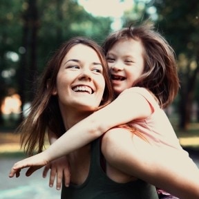 Mother playing with child with special needs. 