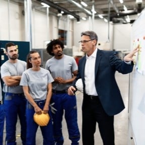 business owner talking to employees