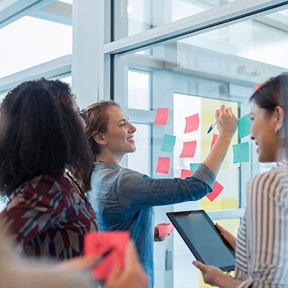 Young office workers brainstorming with sticky notes