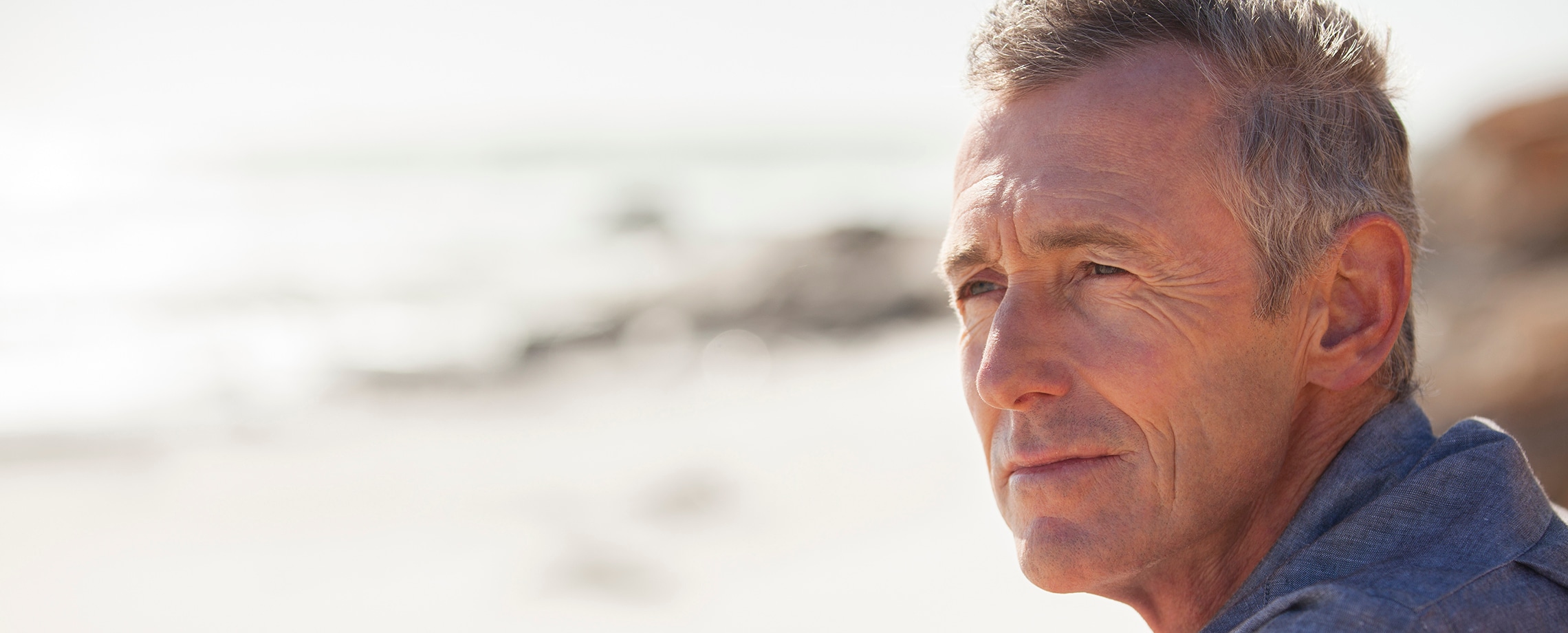 Close up of man sitting by the ocean