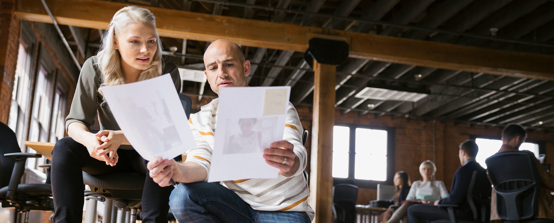 Two office workers collaborating in converted industrial office