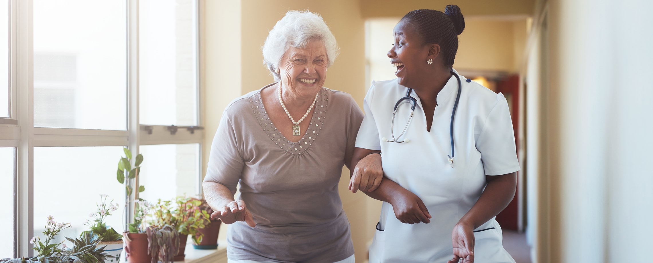 Two ladies in home. Ways to pay for long-term care  