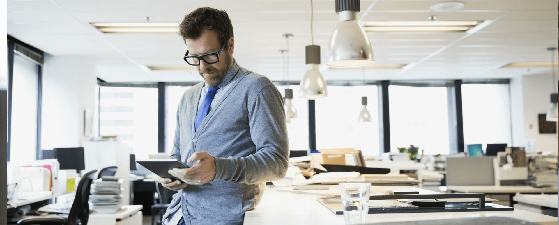 Man in office looking at tablet computer