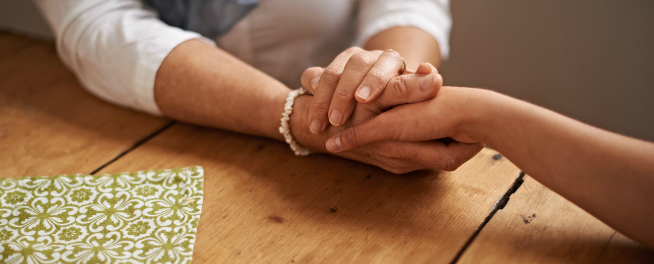 Close up woman's hands holding another hand