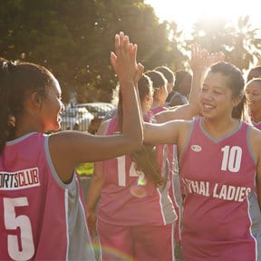 Girls high school sports team high fiving each other