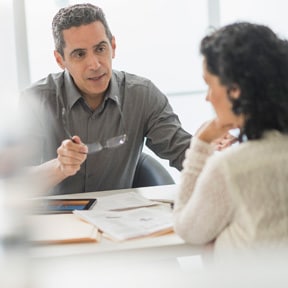 Repeat - Man holding his glasses and seriously explaining something to a woman