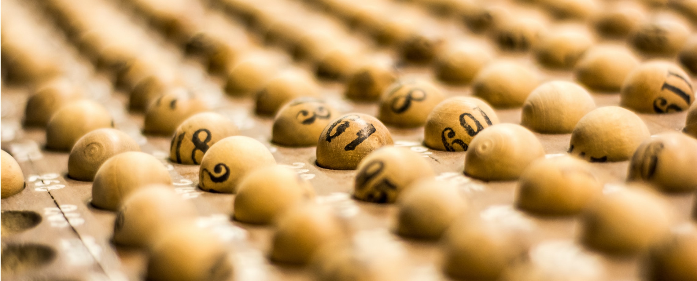 Close up of rows of small wooden balls with numbers printed on them