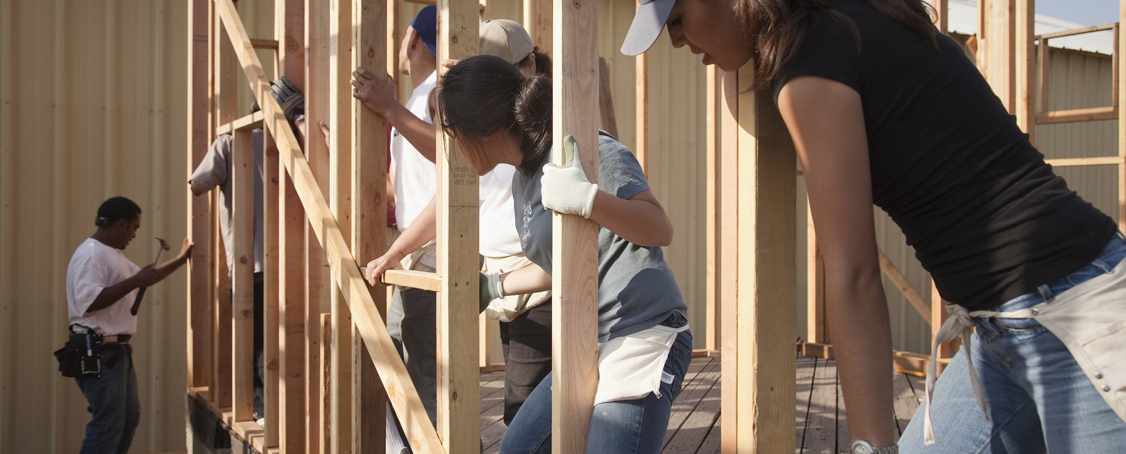 Group of young people helping to build a house