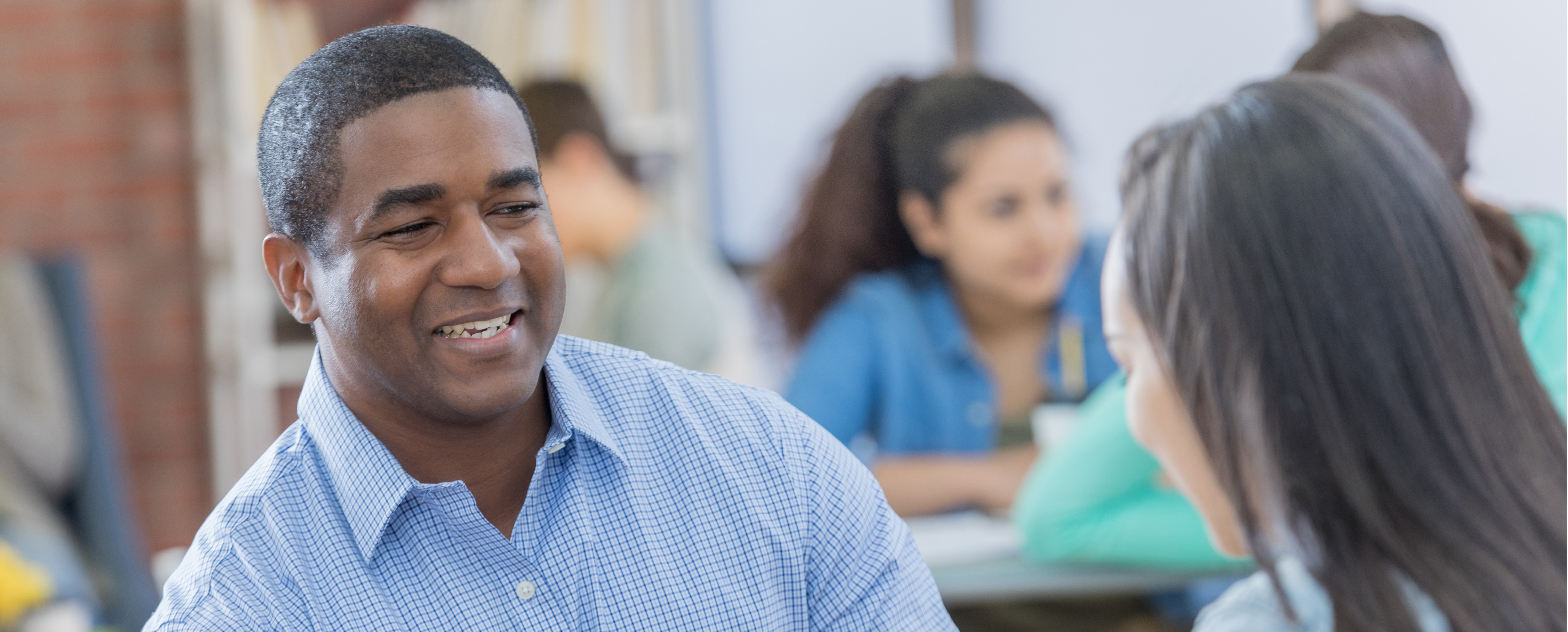 Smiling people of multiple races in conversation