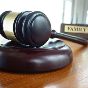 Close up of judge's gavel with the word 'Family' behind
