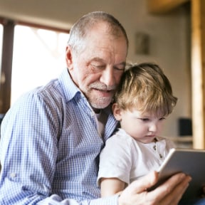 Man and child reading - Custodial accounts and Coverdells: How to use them and who they’re for