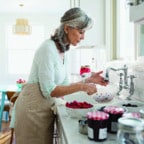 Older woman baking something in kitchen