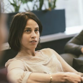 Young, dark haired woman, seated