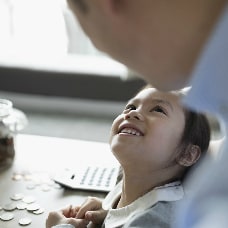 Young girl looking up at her father