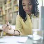 African-American woman working on papers at a desk
