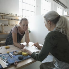 Younger woman and older woman in a pottery studio