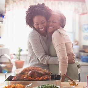 African-American mother and daughter admiring a recently roasted turkey