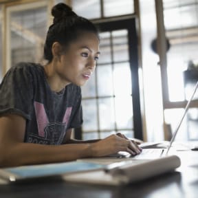 Asian female college student on laptop
