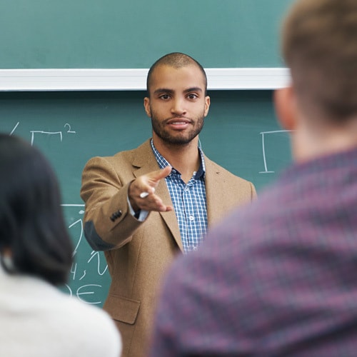 African-American college professor calling on someone in class