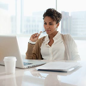 African-American businesswoman looking at her laptop