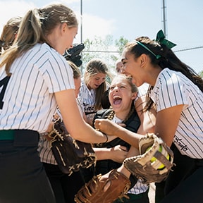 Young girls softball team celebrating