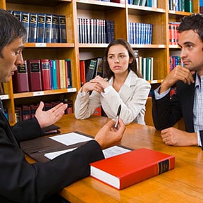 Three businesspeople having a discussion in a library