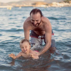 Father teaching baby how to swim